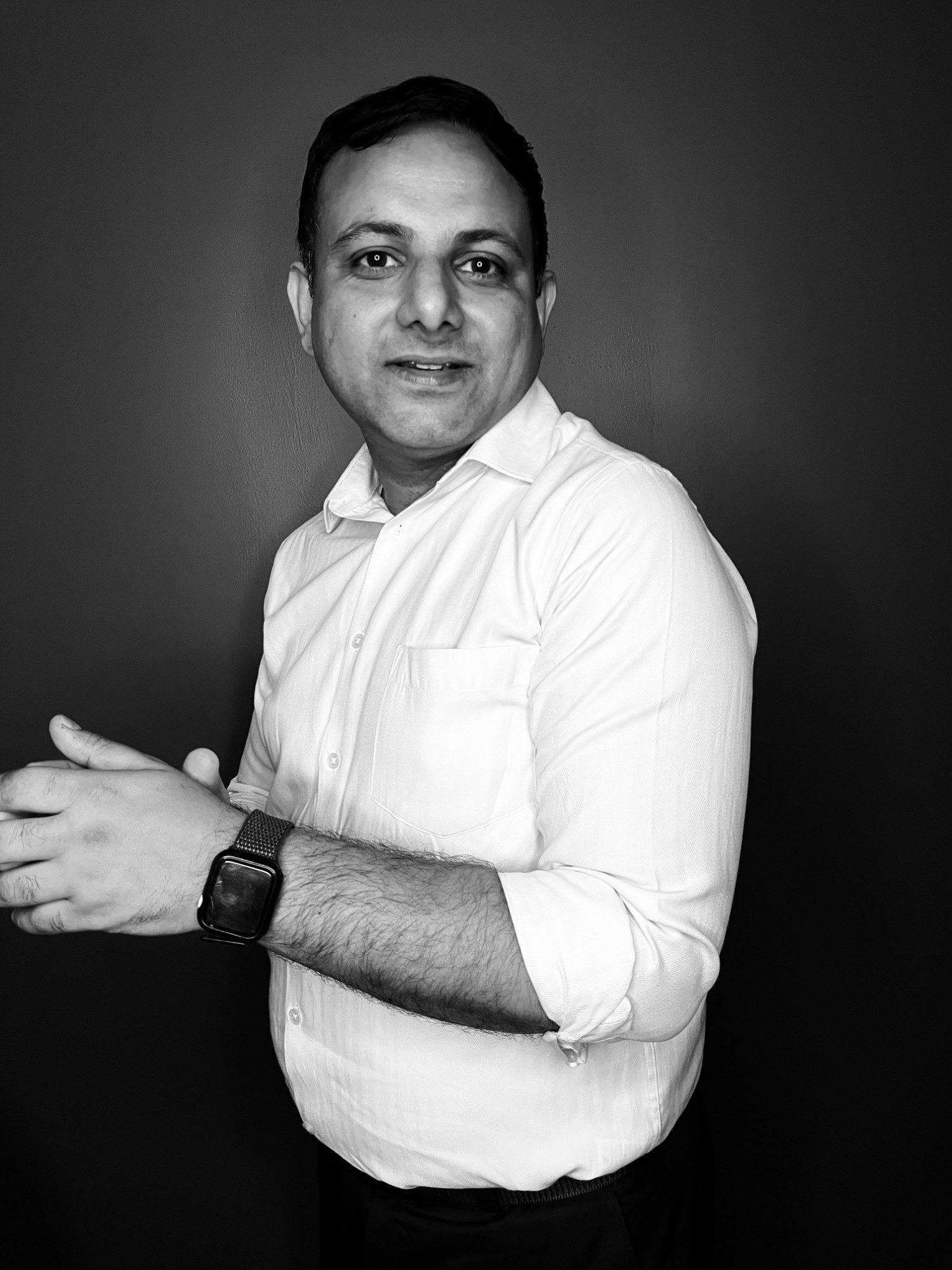 Black and white portrait of Gaurav Singhal in a white shirt